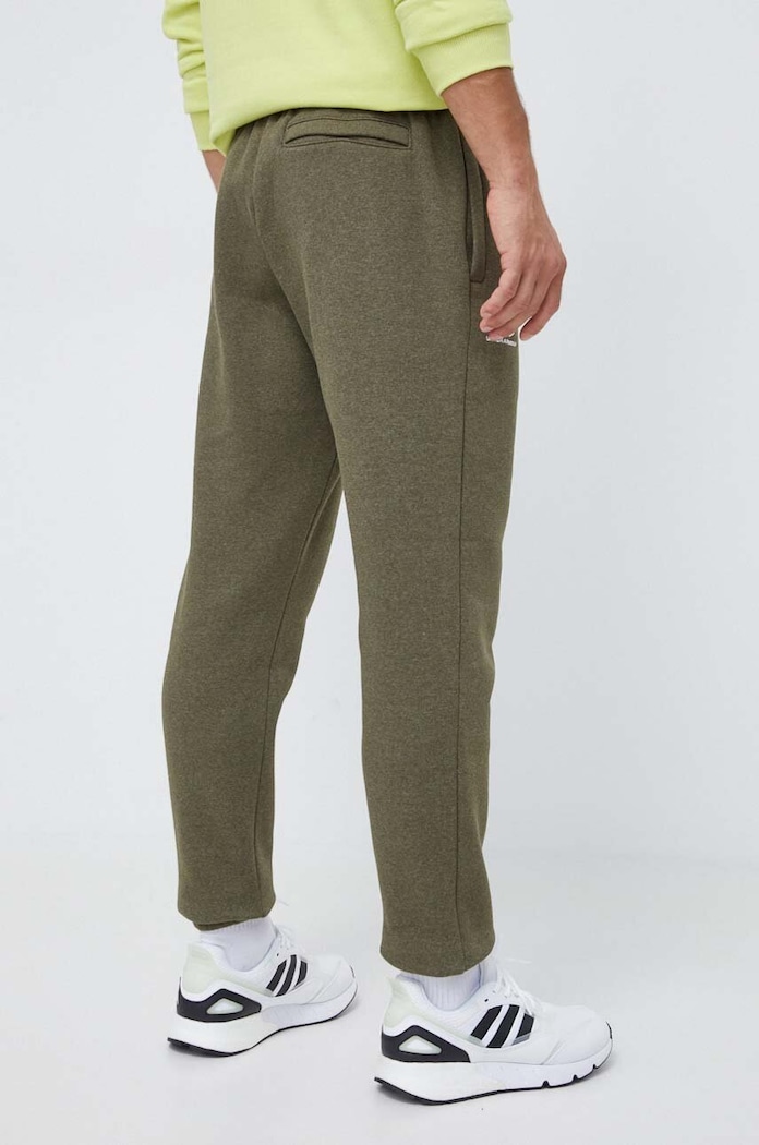 Odzież Under Armour spodnie dresowe męskie z bawełną Essential Fleece 1373882 zielony
