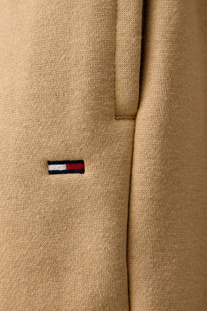 Tepláky pánské s bavlnou Tommy Jeans DM0DM20473 béžová