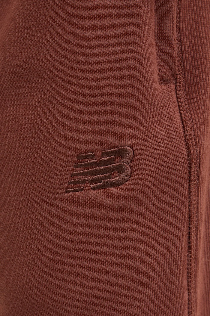Bavlněné tepláky New Balance hnědá MP41508ROK