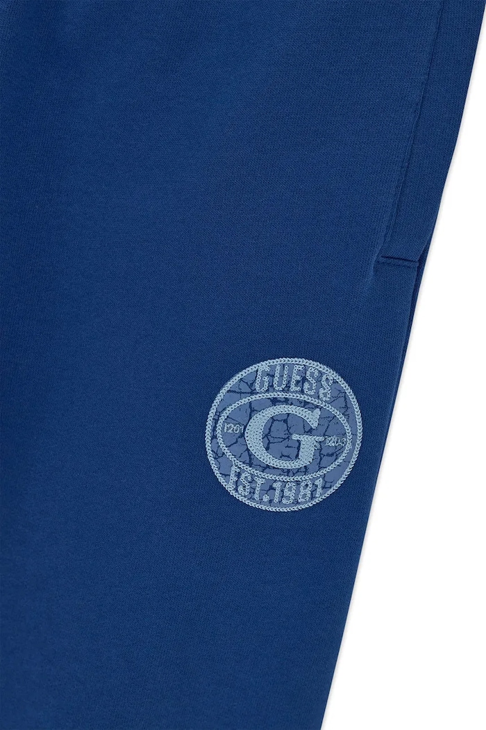Spodnie dresowe dziecięce bawełniane Guess L6BB04.K6069.9BY2 niebieski