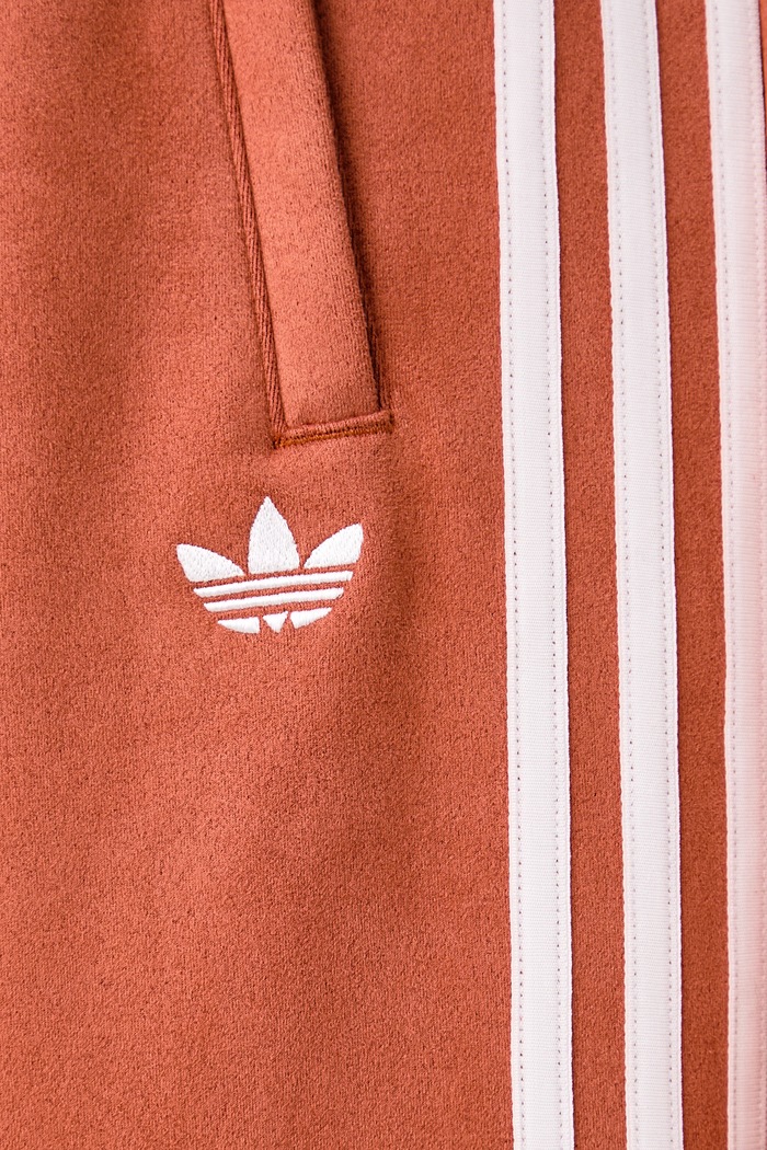 Spodnie dresowe damskie Adilenium Season 6 Faux Suede adidas Originals pomarańczowy LH1926