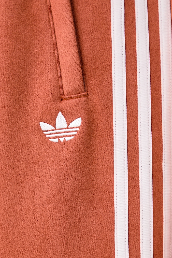 Spodnie dresowe damskie Adilenium Season 6 Faux Suede adidas Originals pomarańczowy LH1926