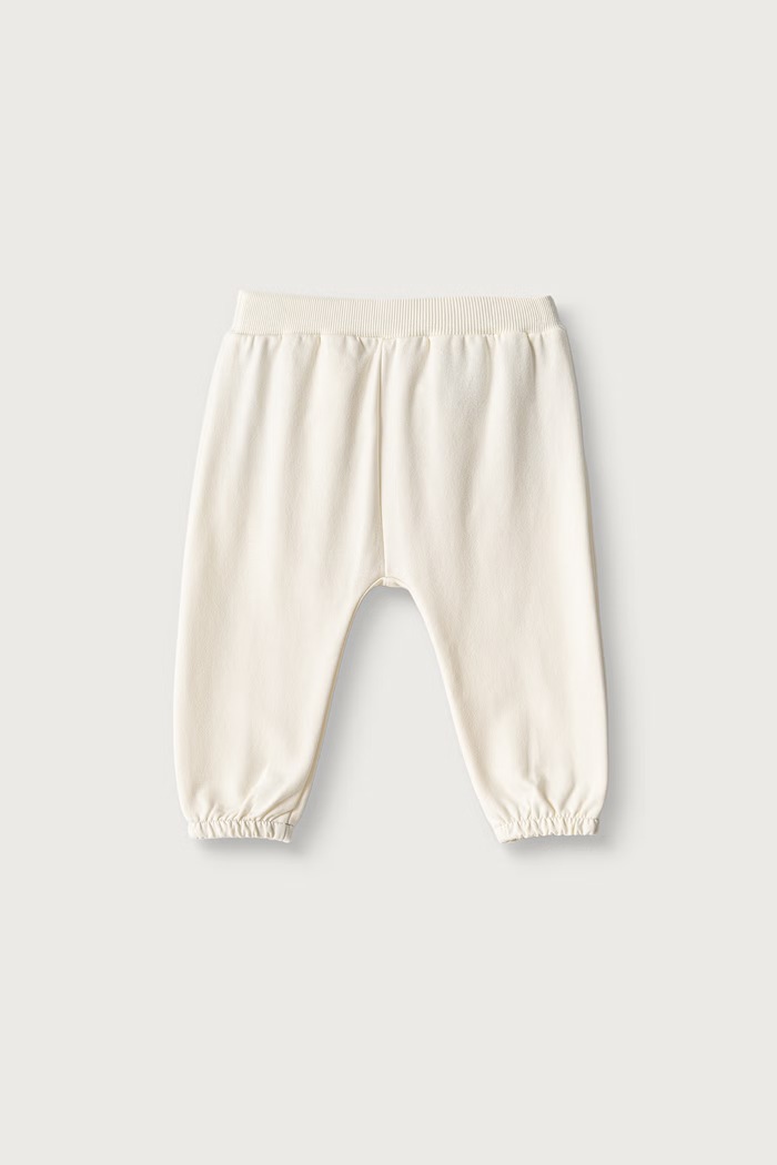 United Colors of Benetton Spodnie dresowe niemowlęce z bawełną 3YWVAF02P.W.Seasonal beżowy AW26