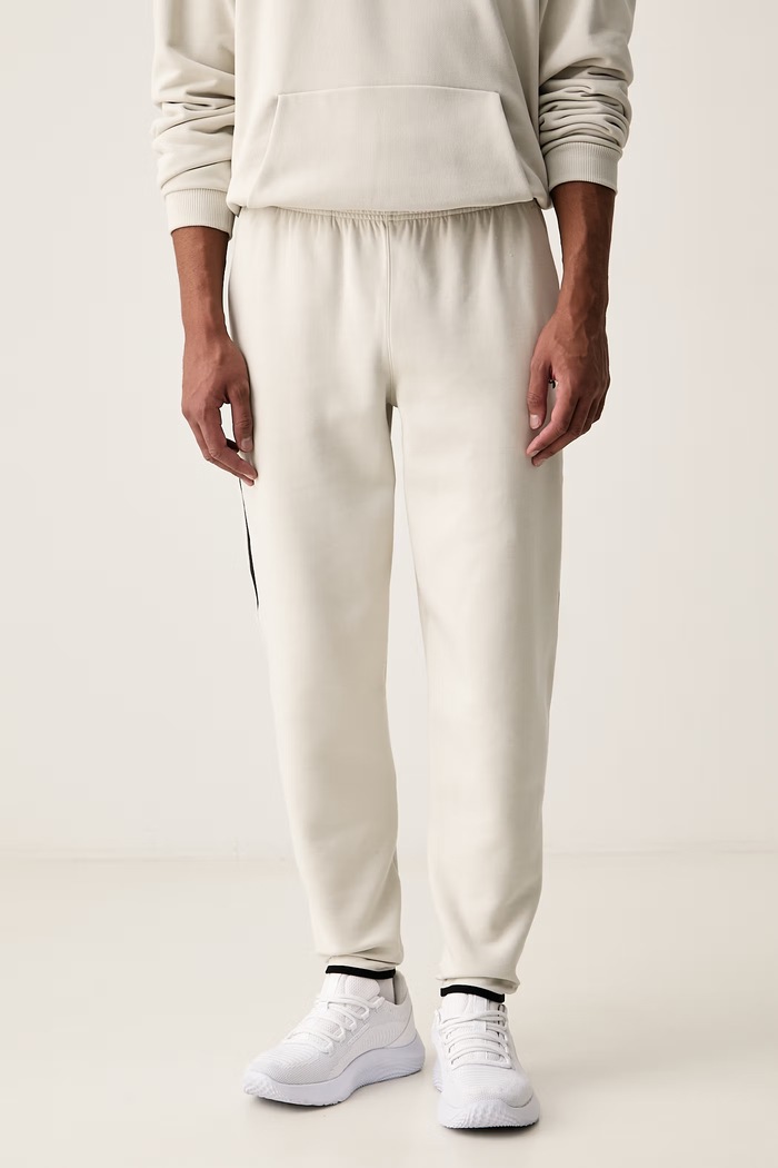 Under Armour Spodnie dresowe męskie Unstoppable beżowy 6013427