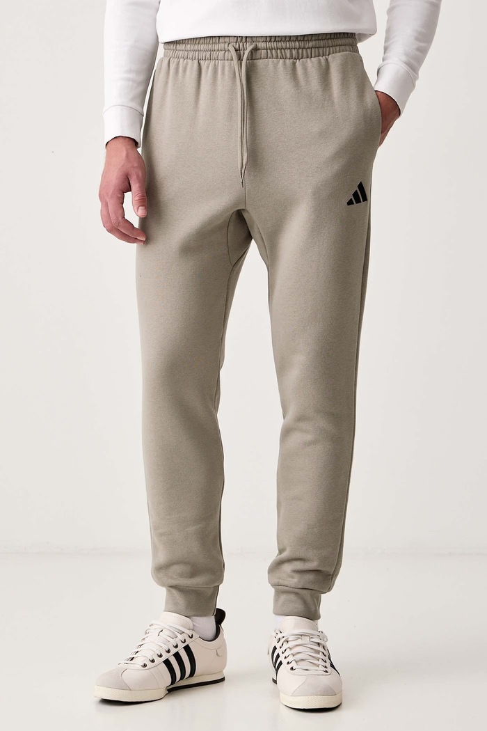 adidas Spodnie dresowe męskie z bawełną Essentials Feelcozy zielony KF2381