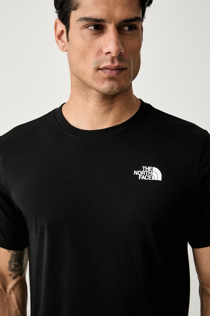 The North Face kratka majica moška z bombažem GRAPHIC črna NF0A8GV0JK31