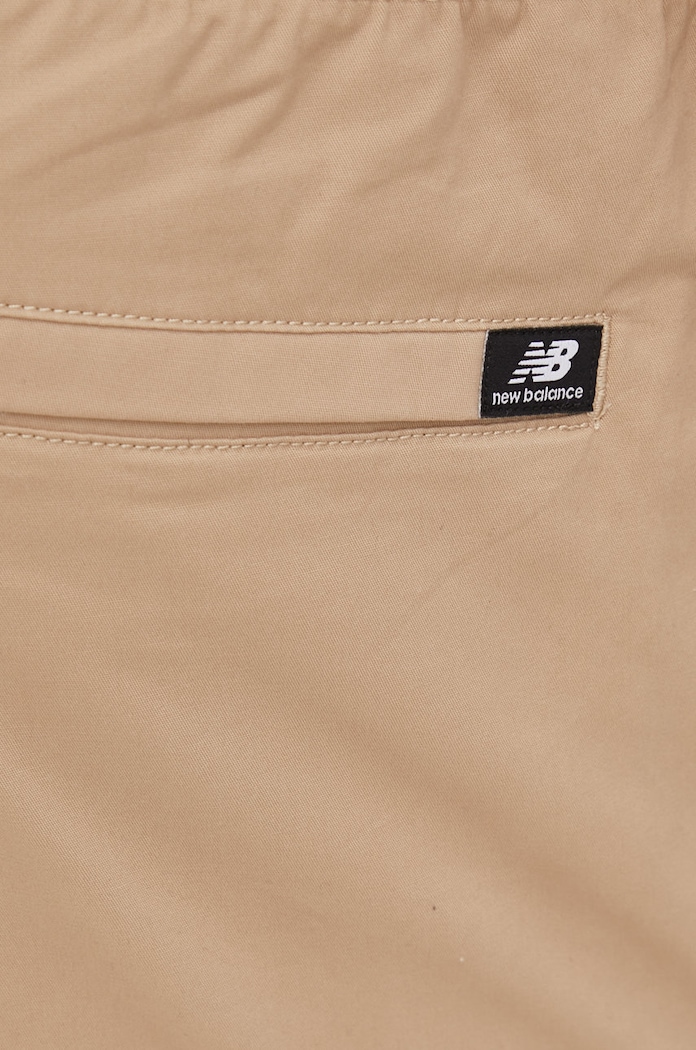 Hlače New Balance bež MP13501INC