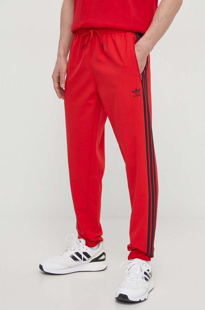 Tepláky adidas Originals látka červená IS2808