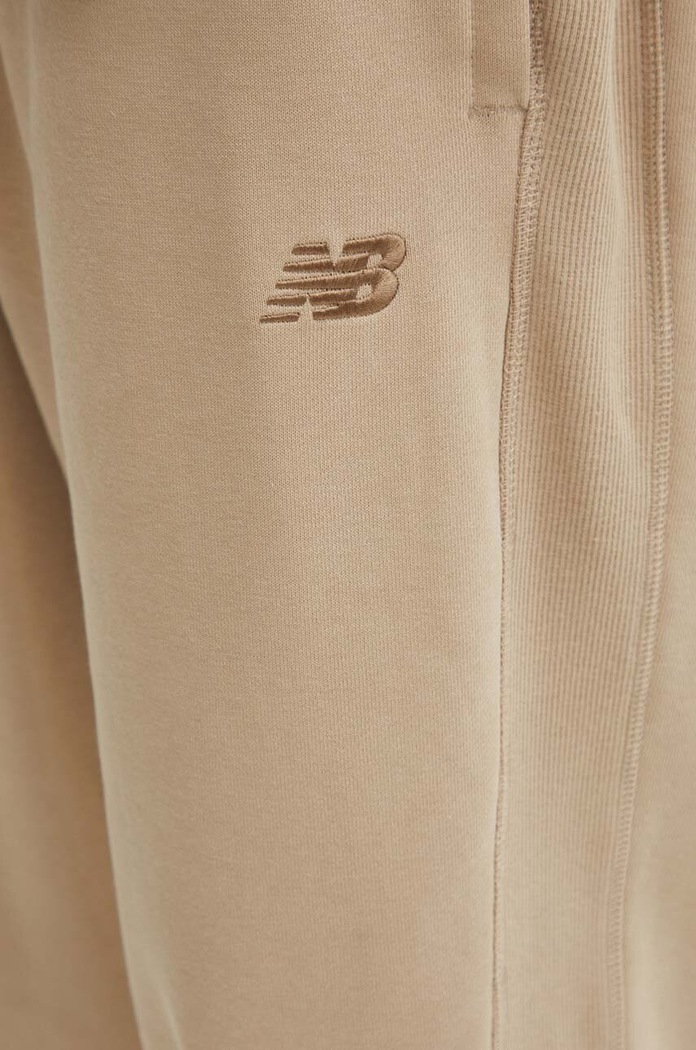 New Balance spodnie dresowe bawełniane MP41508SOT beżowy MP41508SOT