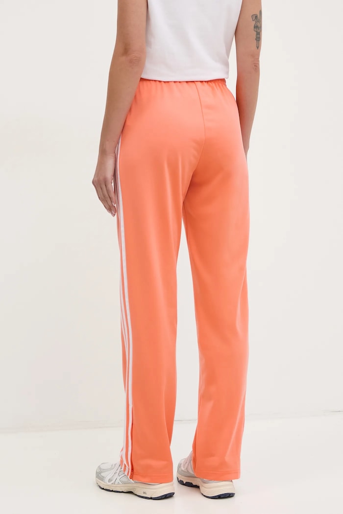 Odzież adidas Originals spodnie dresowe Firebird JC8286 pomarańczowy