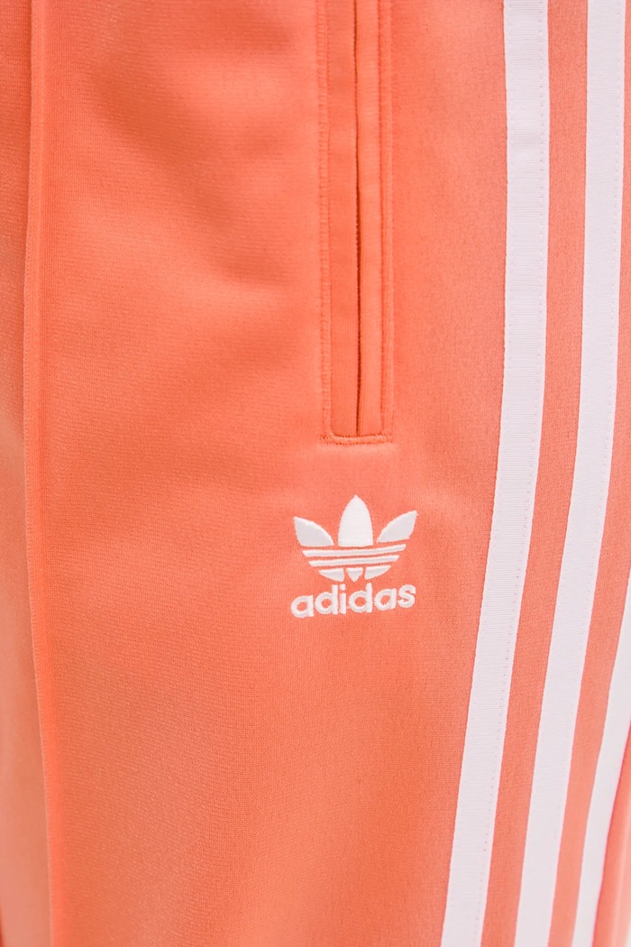 adidas Originals spodnie dresowe Firebird pomarańczowy JC8286