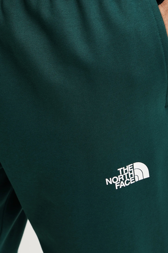 Spodnie dresowe Simple Dome The North Face NF0A8C1W6GI1 zielony