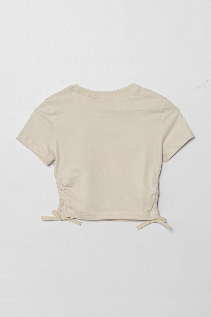 Puma t-shirt bawełniany dziecięcy FLAMING LOVE Knotted Tee 685108.G beżowy SS25