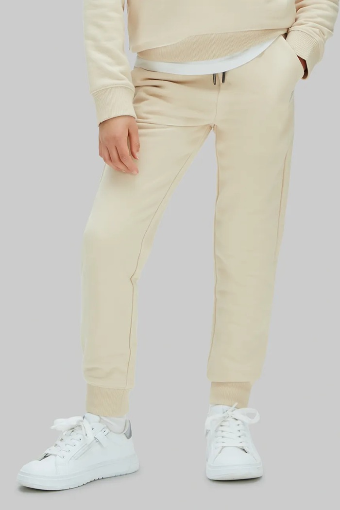 Calvin Klein Jeans teplákové nohavice detské s bavlnou béžová LV1CKSJC53.128.176.PPY2