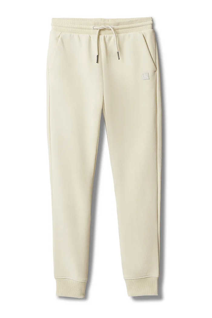 Calvin Klein Jeans teplákové nohavice detské s bavlnou LV1CKSJC53.128.176.PPY2 béžová SS26
