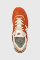 orange New Balance sneakers 574