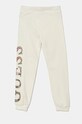 Guess spodnie dresowe bawełniane dziecięce J4BQ11.KAX73.9BYH beżowy AW24