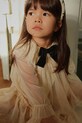 Konges Sløjd sukienka dziecięca BOW DRESS rozkloszowany beżowy KS104240.9BYA