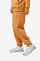 New Balance spodnie dresowe bawełniane pomarańczowy