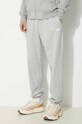 Tepláky New Balance Sport Essentials jednofarebný sivá MP41519AG