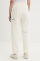 Odzież Converse spodnie dresowe damskie CVW6B094 beżowy