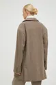 Μάλλινο παλτό Herskind  Κύριο υλικό: 70% Ανακυκλωμένος πολυεστέρας, 10% Πολυαμίδη Φόδρα: 100% Oξικό άλας