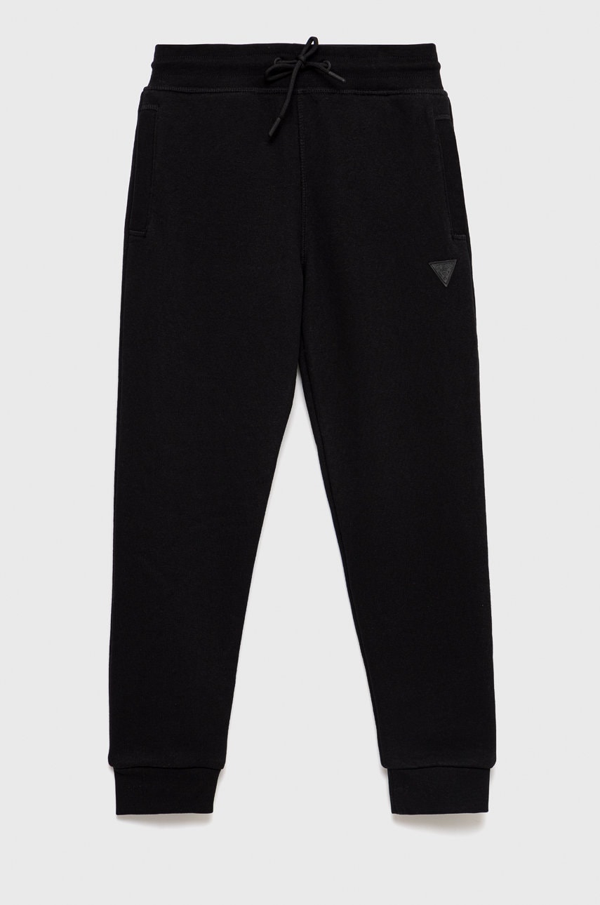 Levně Dětské tepláky Guess černá barva, melanžové