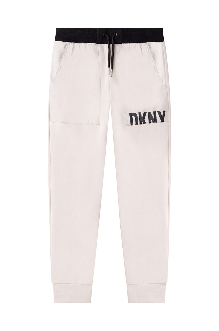 

Дитячі спортивні штани Dkny колір бежевий з принтом