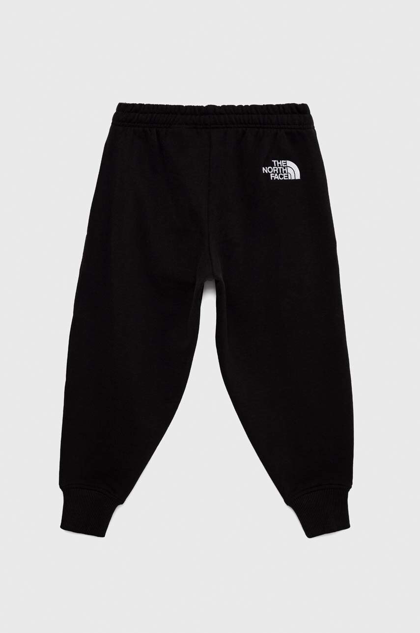 

Детские хлопковые штаны The North Face цвет чёрный с принтом