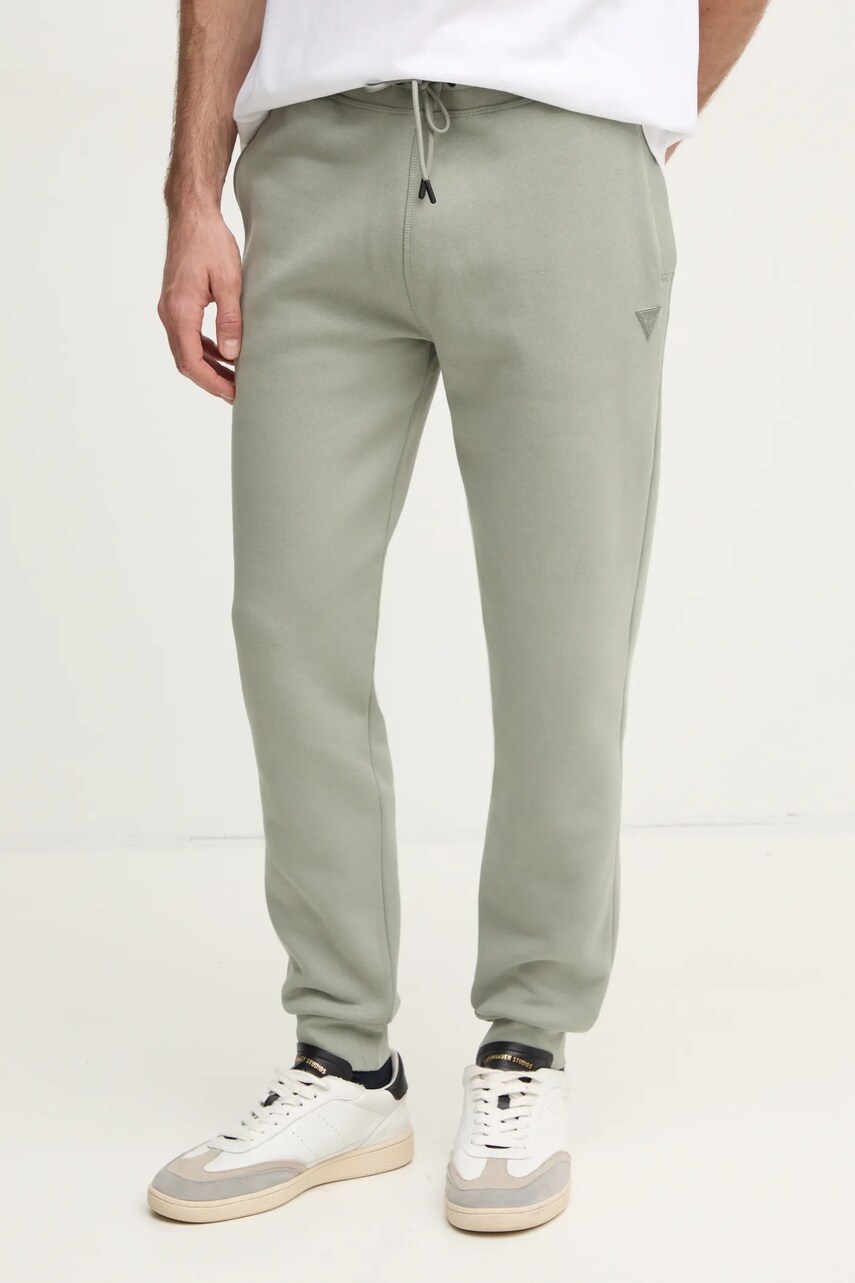 Levně Tepláky Guess zelená barva, melanžové