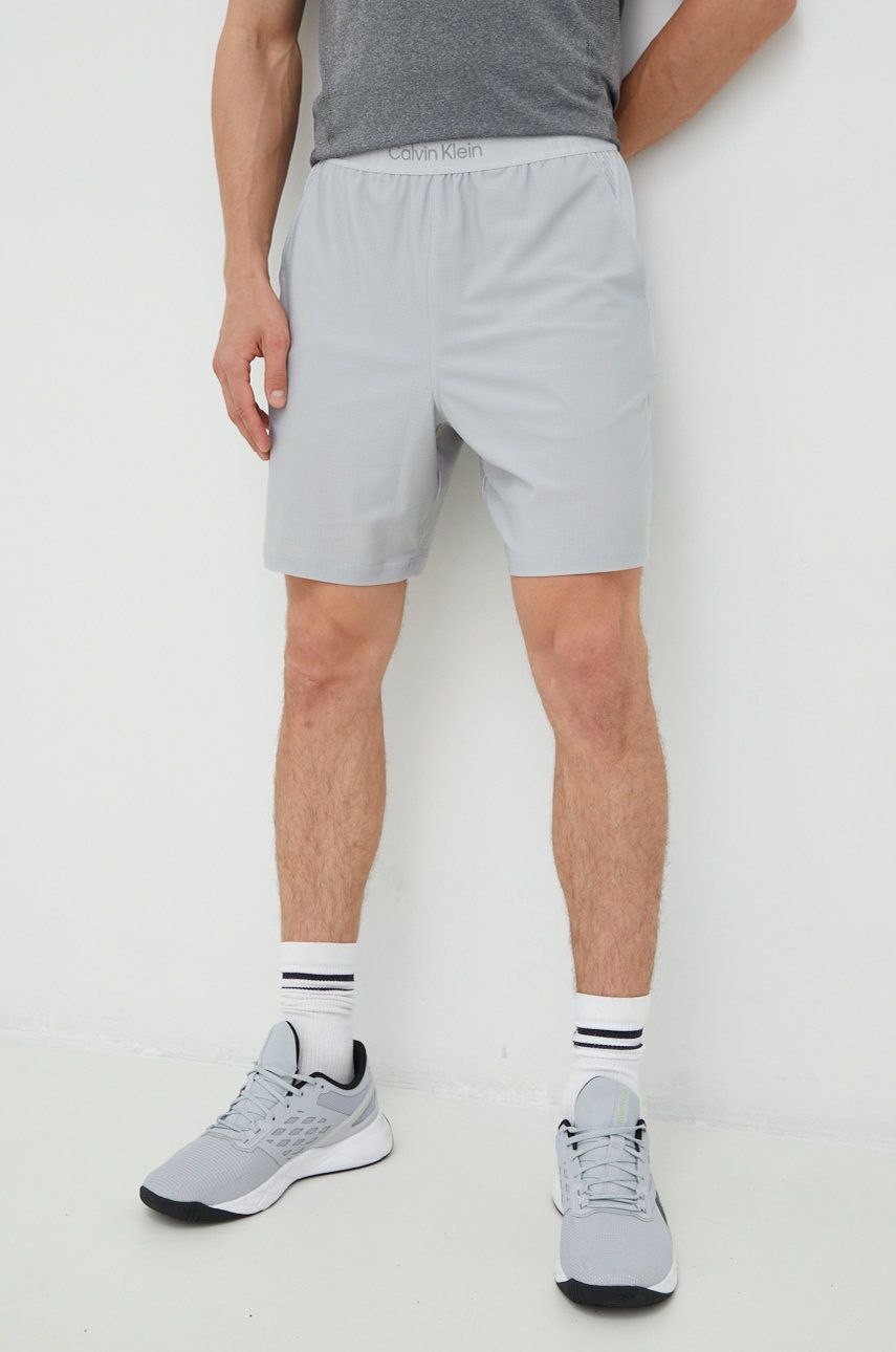 Levně Tréninkové šortky Calvin Klein Performance pánské, šedá barva