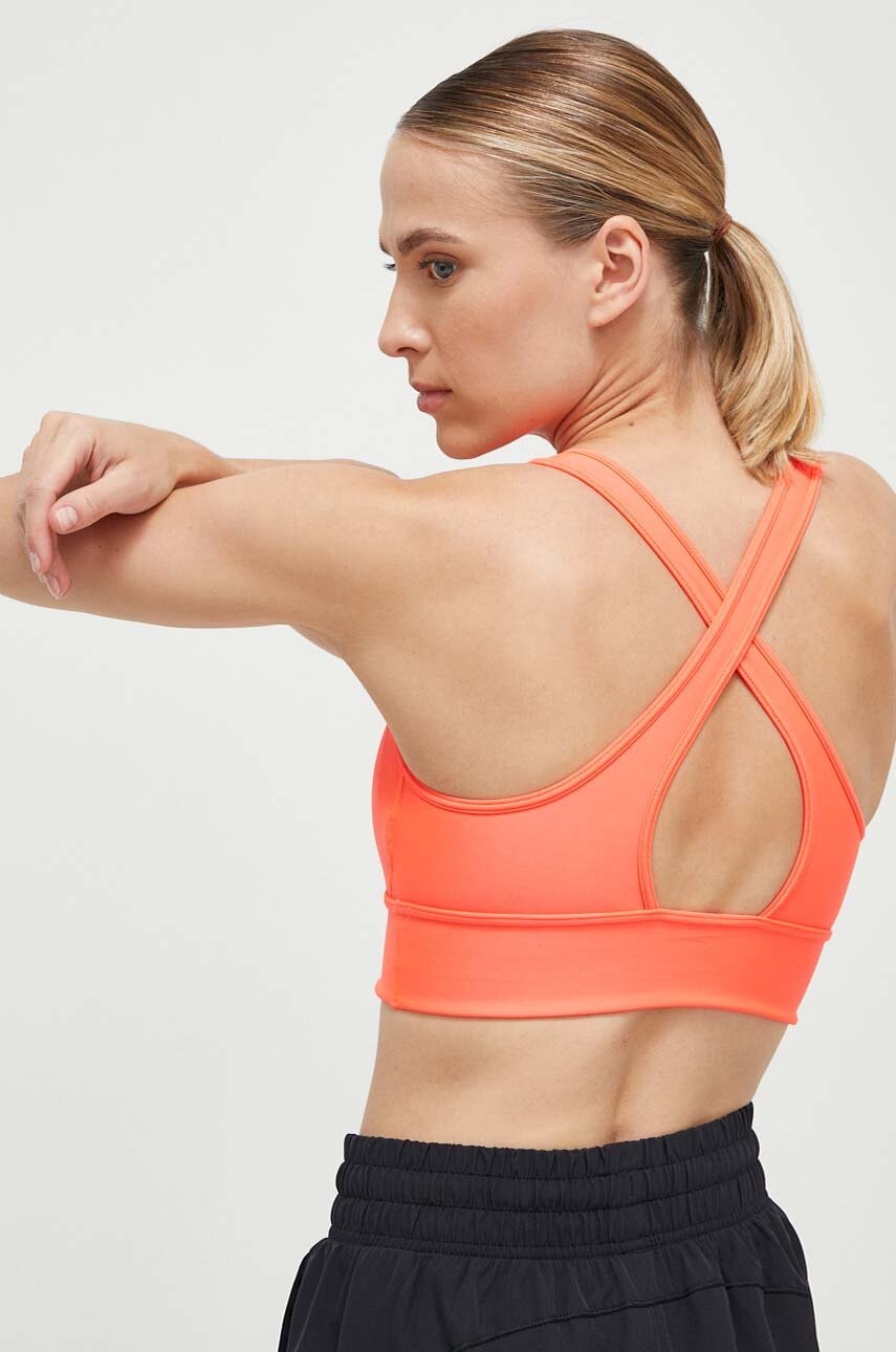 Levně Sportovní podprsenka Under Armour Crossback oranžová barva