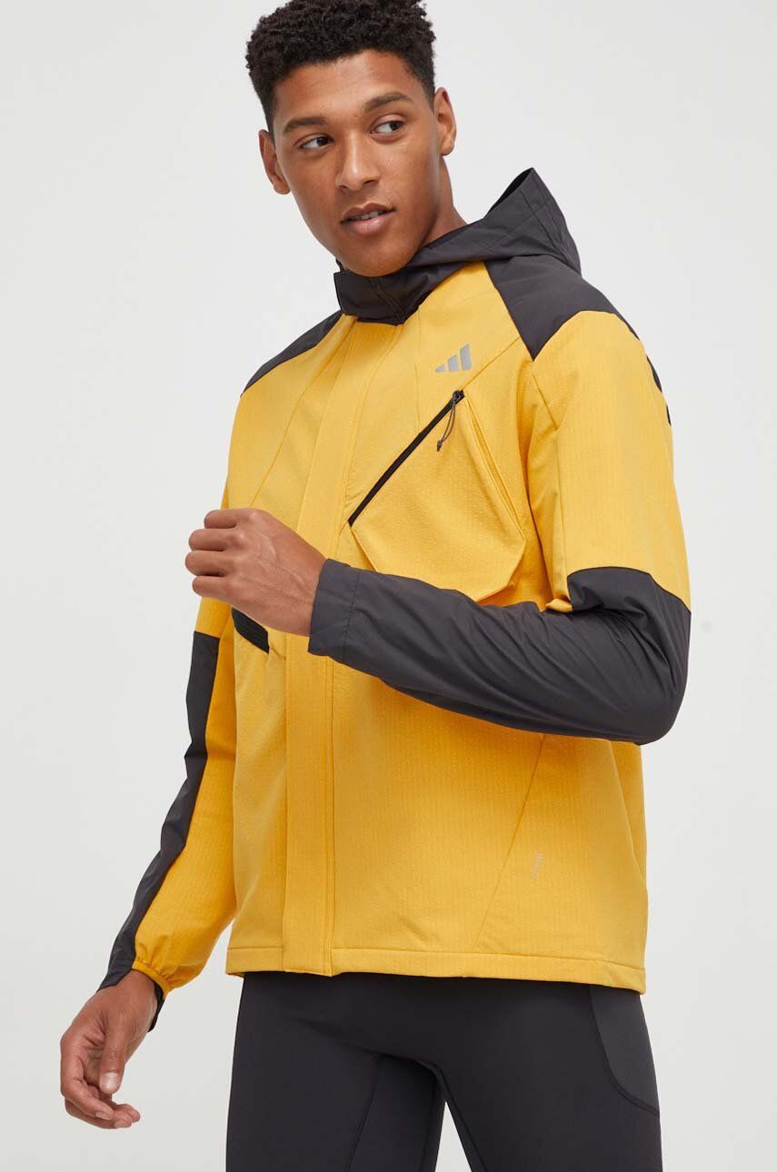 Levně Běžecká bunda adidas Performance žlutá barva