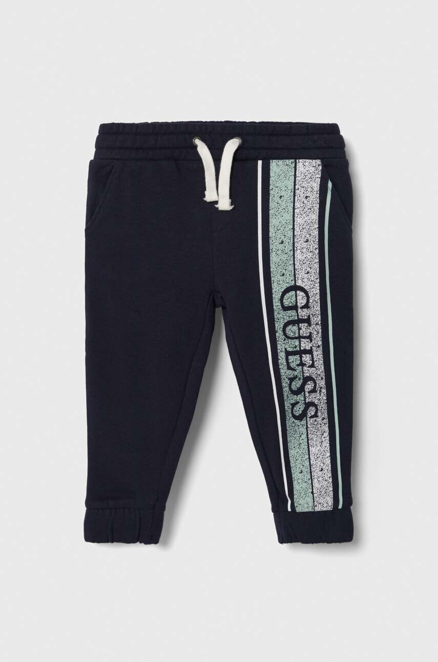 

Дитячі бавовняні штани Guess колір синій з принтом