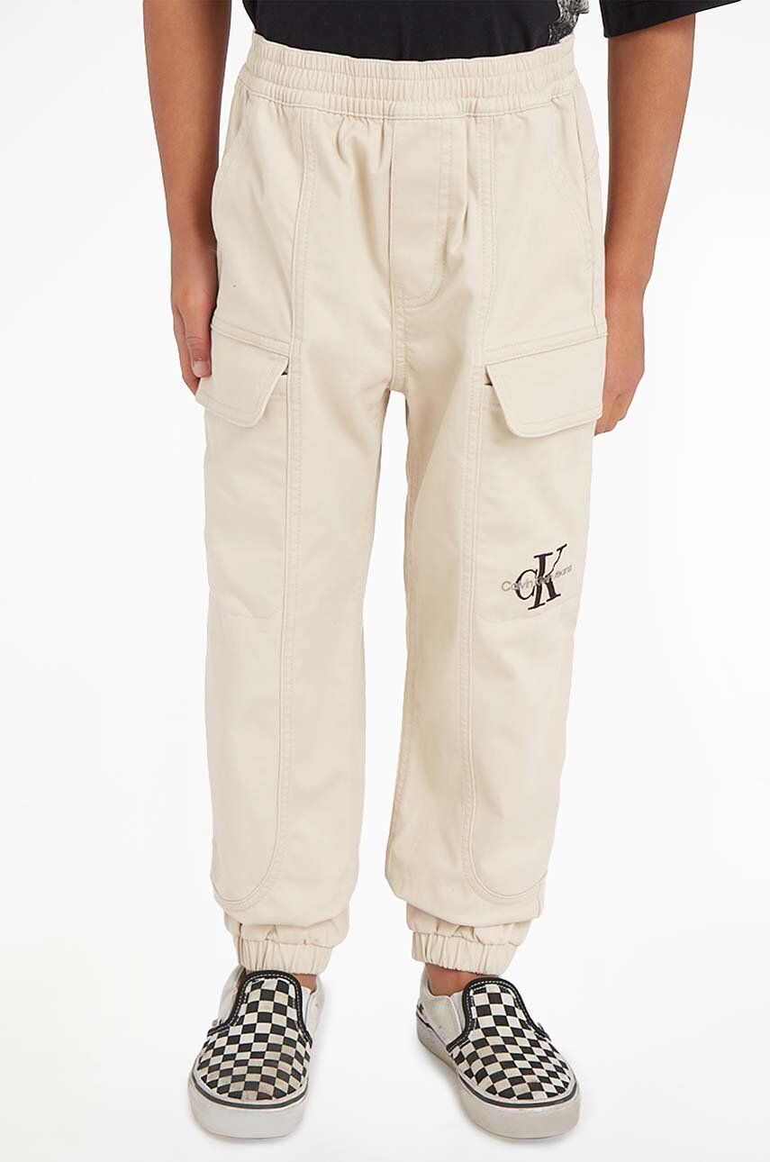 Levně Dětské kalhoty Calvin Klein Jeans béžová barva, hladké