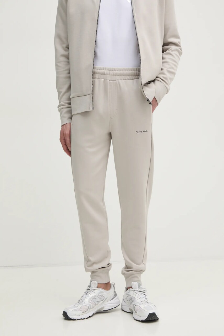 Levně Tepláky Calvin Klein béžová barva, hladké