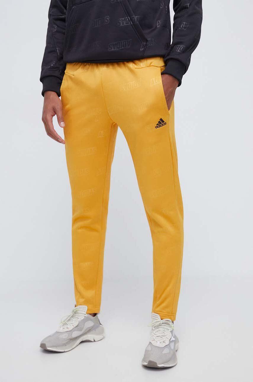 Levně Tepláky adidas žlutá barva, vzorované