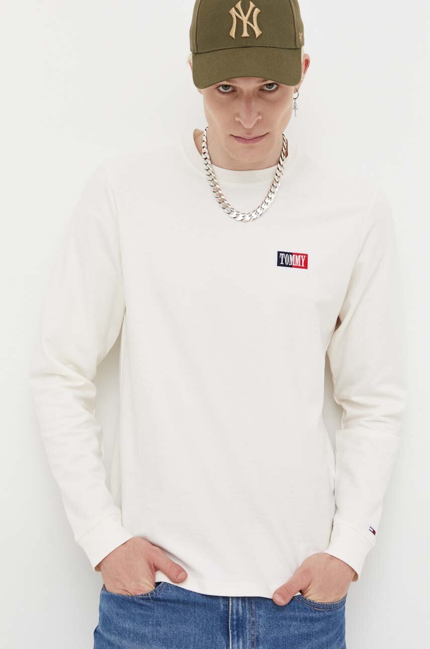 

Бавовняний лонгслів Tommy Jeans колір бежевий з аплікацією