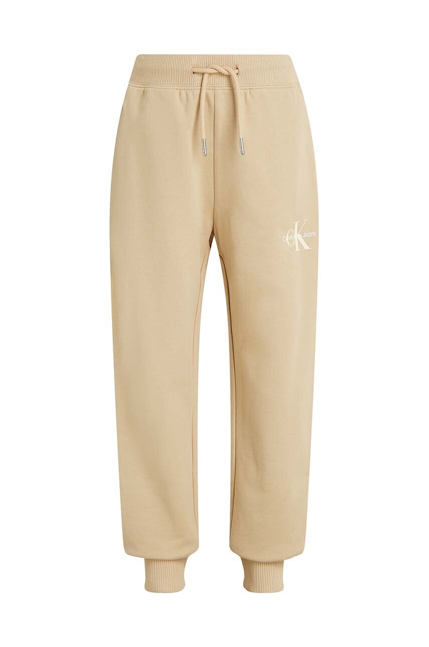 Levně Dětské bavlněné tepláky Calvin Klein Jeans MONOGRAM LOGO béžová barva, IU0IU00285