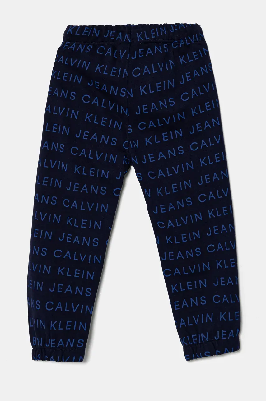 Otroška Bombažna Trenirka Calvin Klein Jeans AOP JOGGER Mornarsko Modra Barva, IB0IB02323