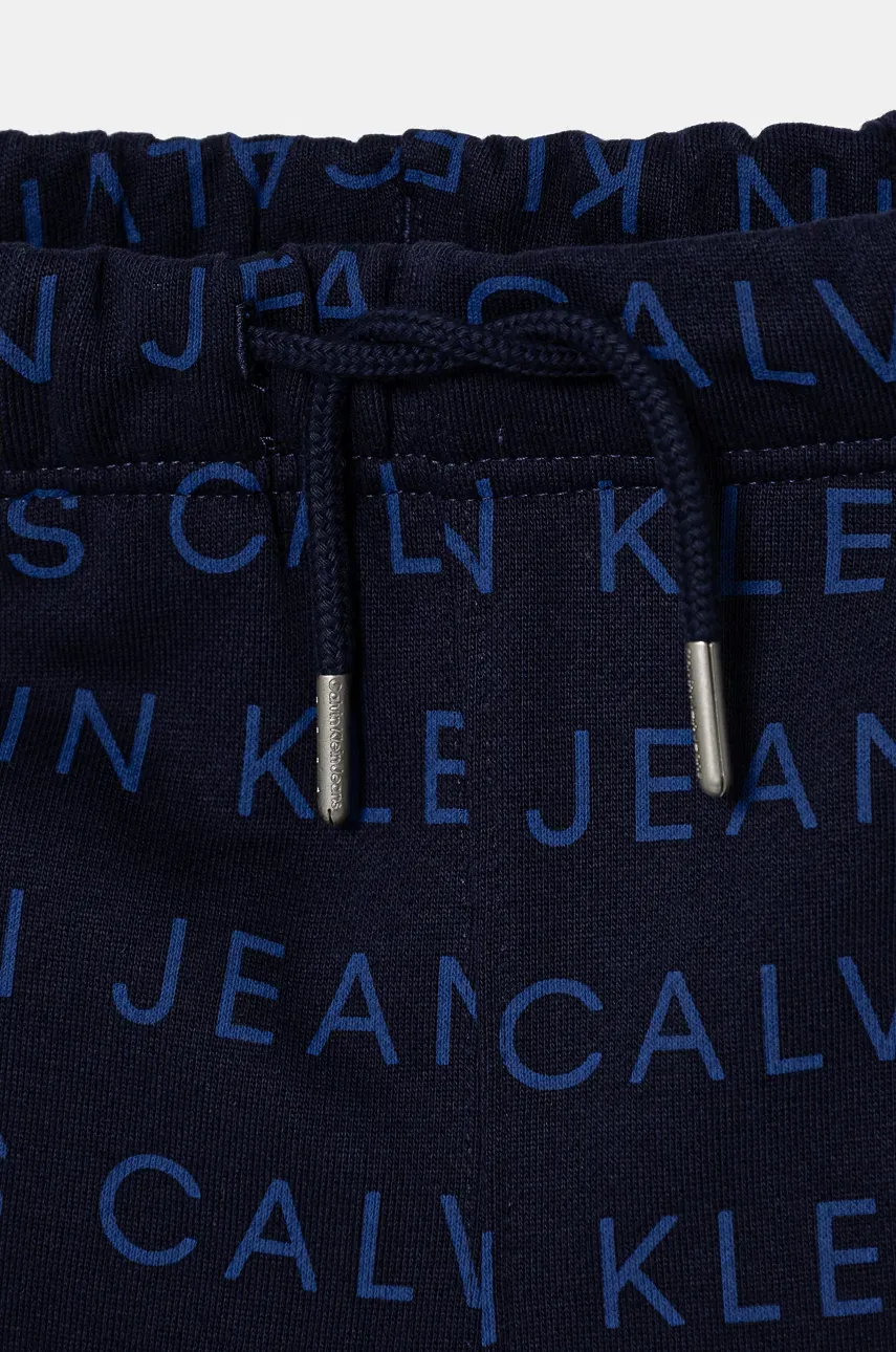 Otroška Bombažna Trenirka Calvin Klein Jeans AOP JOGGER Mornarsko Modra Barva, IB0IB02323