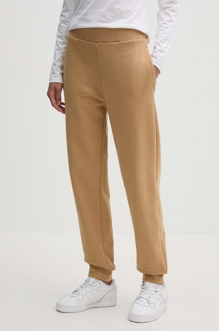 Levně Tepláky Calvin Klein béžová barva, hladké, K20K207214