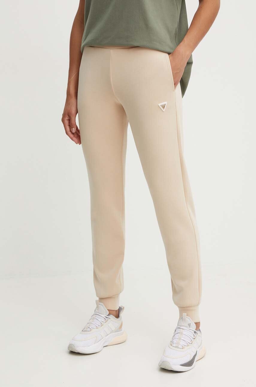Levně Tepláky Guess OLYMPE béžová barva, hladké, V4YB08 KCAY2