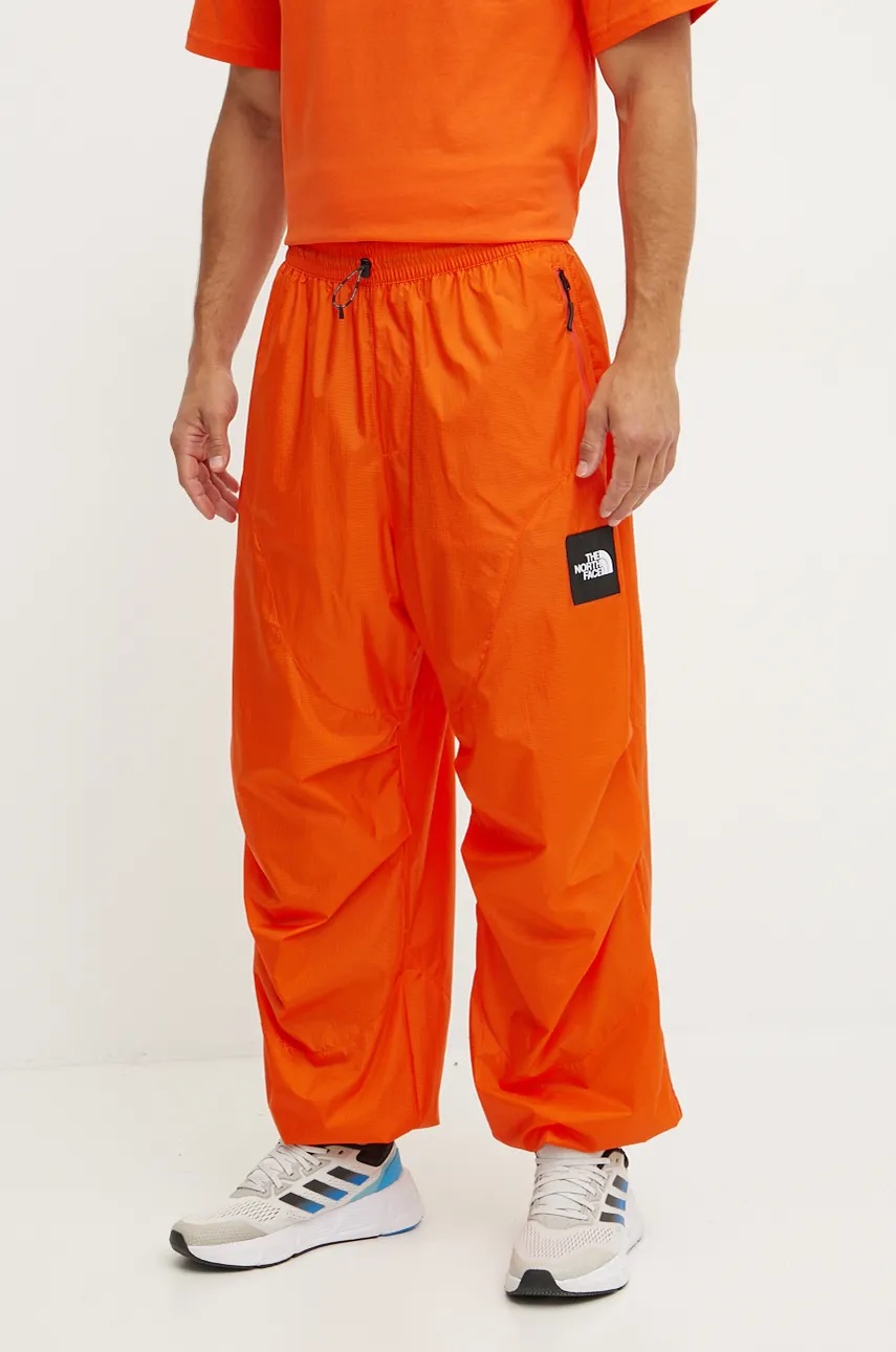 The North Face pantaloni TNF x Yinka Ilori culoarea portocaliu, cu imprimeu, NF0A89GPA6M1
