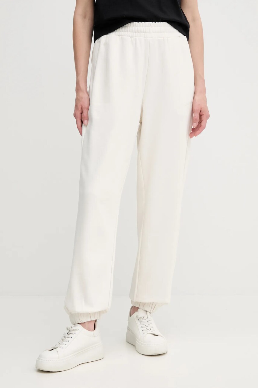 Levně Bavlněné tepláky Calvin Klein dámské, béžová barva, LV044C904G