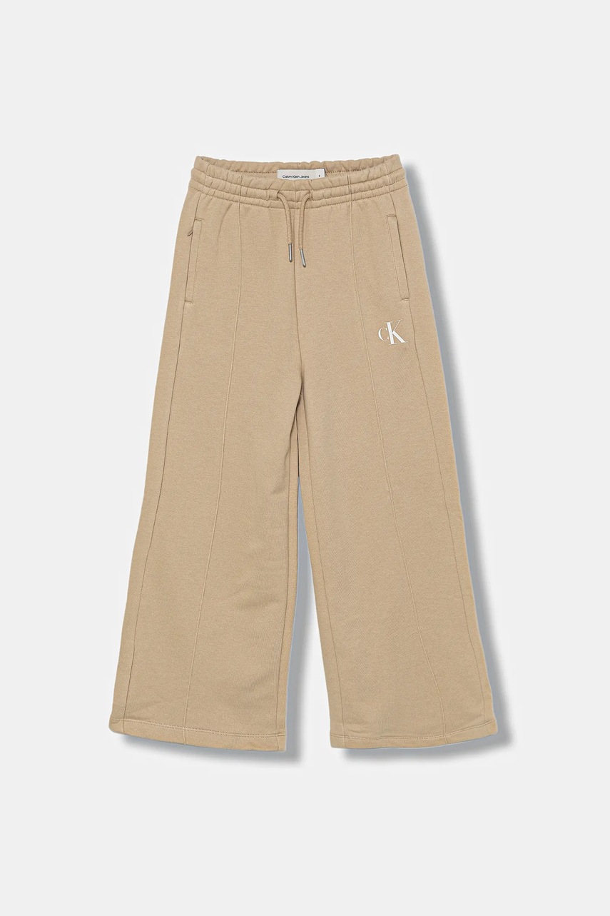 Детские спортивные штаны Calvin Klein Jeans цвет бежевый с принтом IG0IG02875