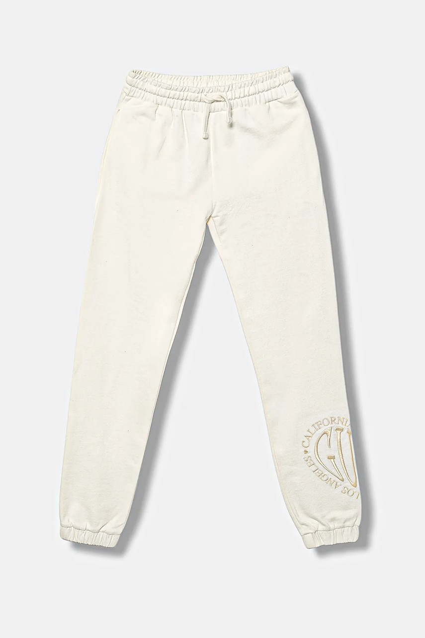 Levně Dětské bavlněné tepláky Guess béžová barva, s aplikací, J5YQ16 KAD74