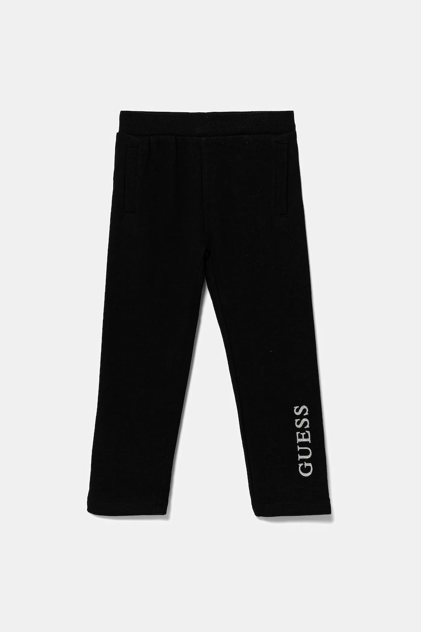 Levně Dětské bavlněné tepláky Guess černá barva, s potiskem, K5YQ12 KA6R4
