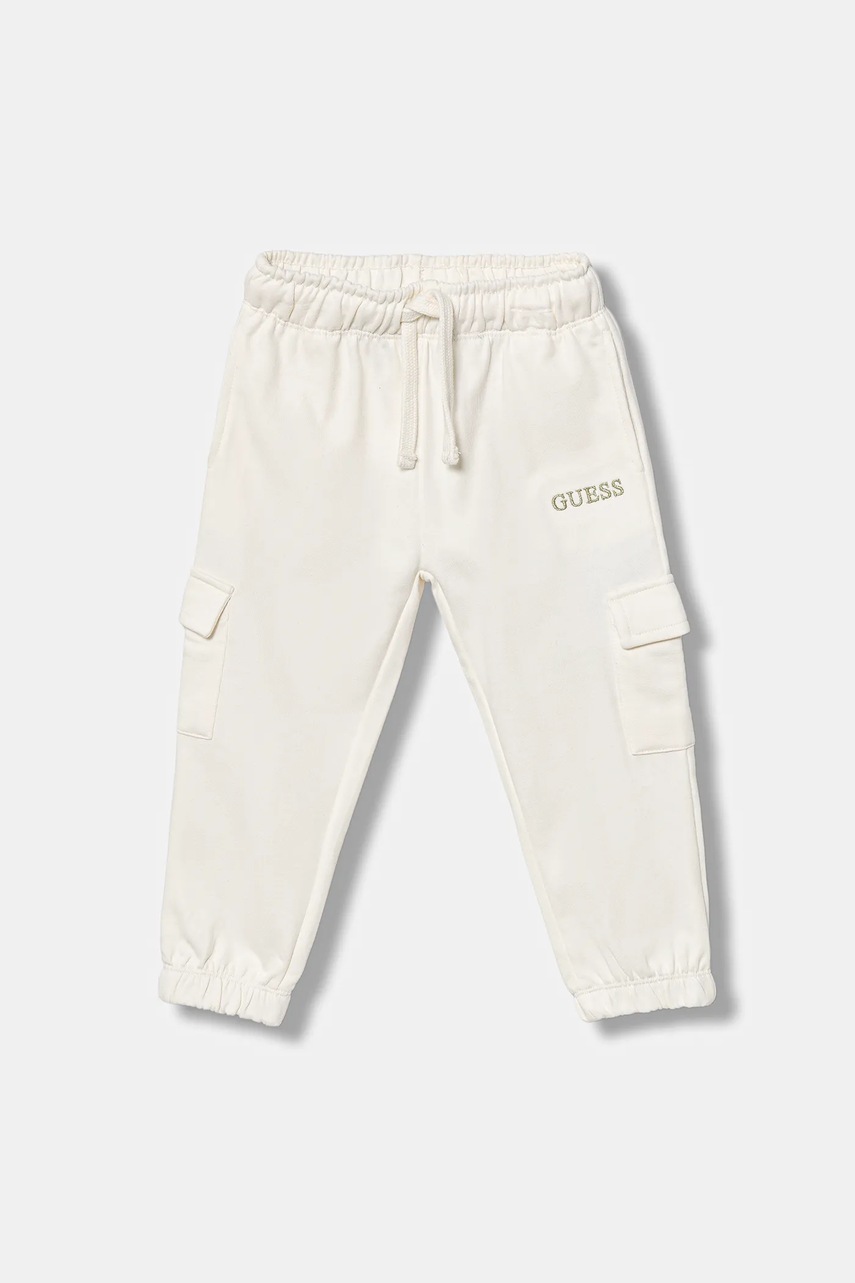 Levně Dětské bavlněné tepláky Guess béžová barva, s aplikací, K5YQ16 KA6R4