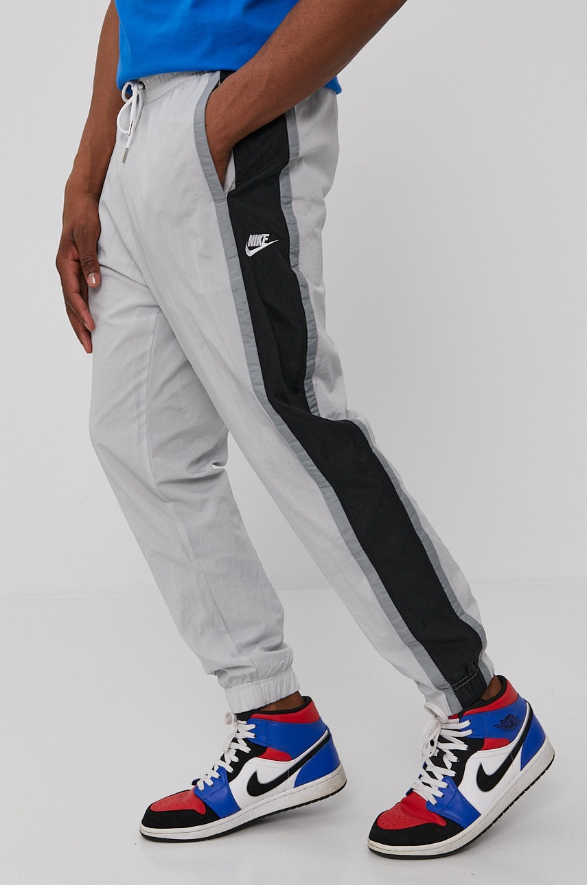 

Брюки Nike Sportswear мужские цвет серый гладкие